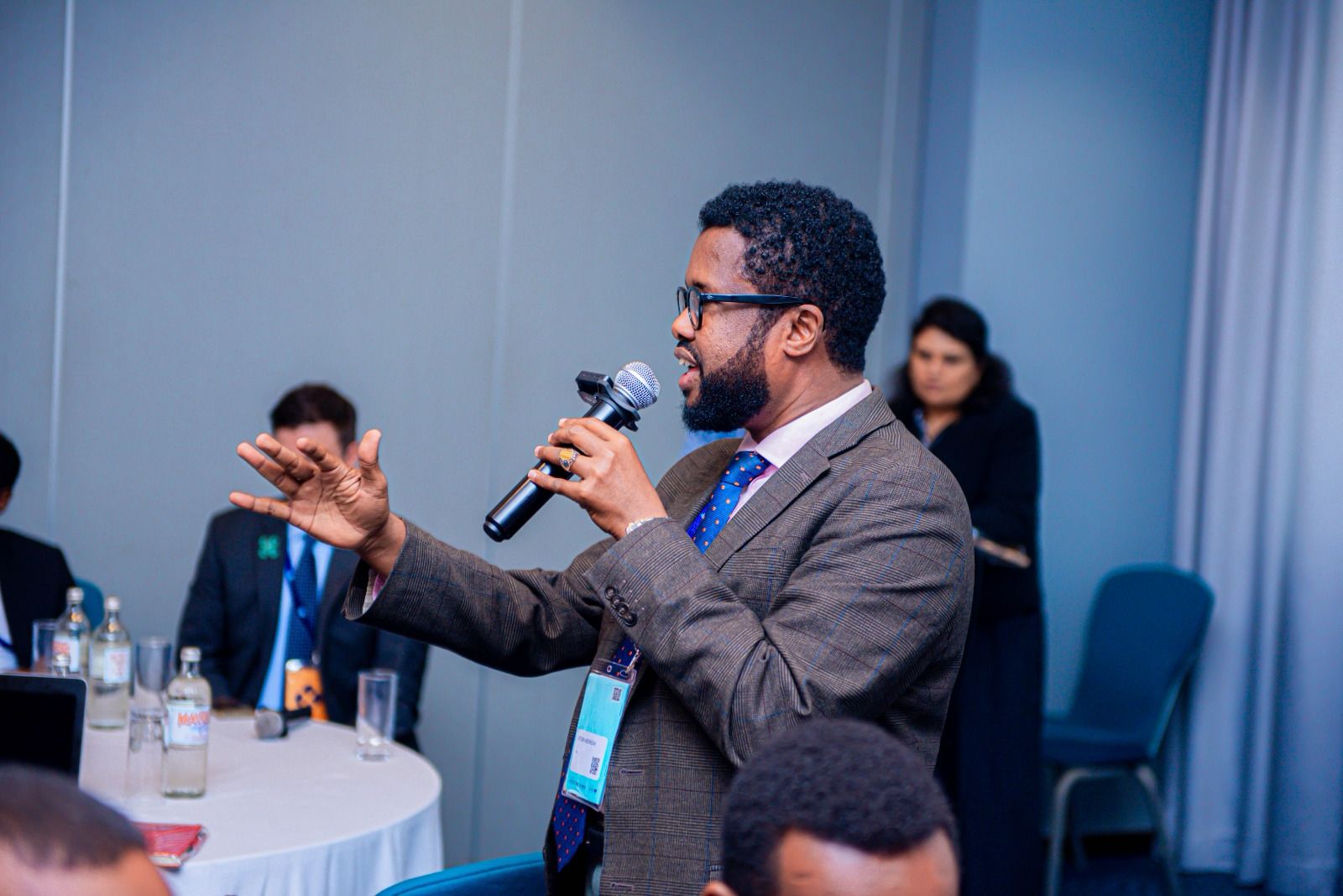 Atosh addressing a conference